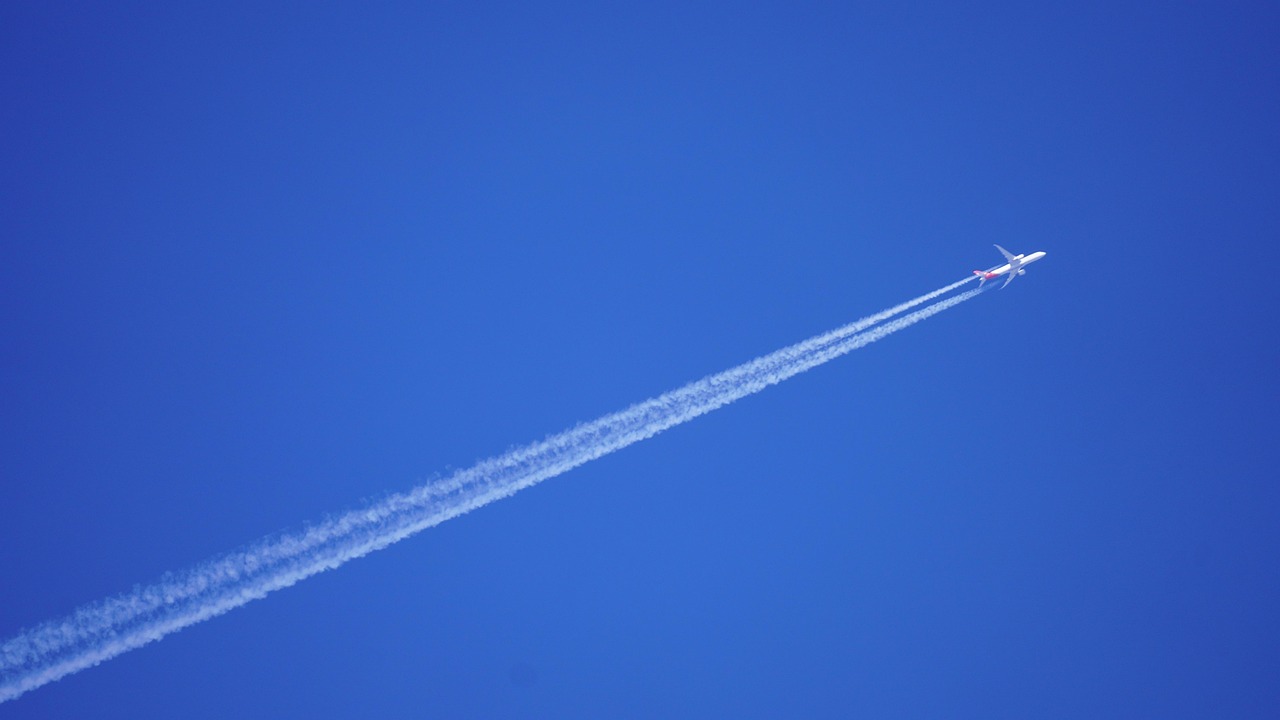 Is Turbulence Really Getting Worse? What the 2026 Data Shows 2 Jet airliner flying at cruising altitude leaving a contrail across a deep blue sky