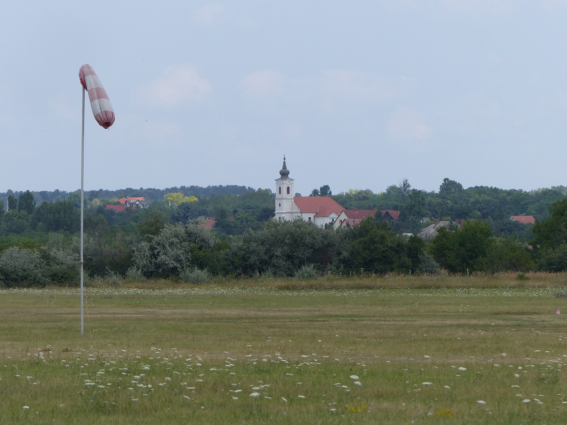 Does a Student Pilot Certificate Expire? What It Lets You Do 4 A windsock beside a grass runway at a small airfield