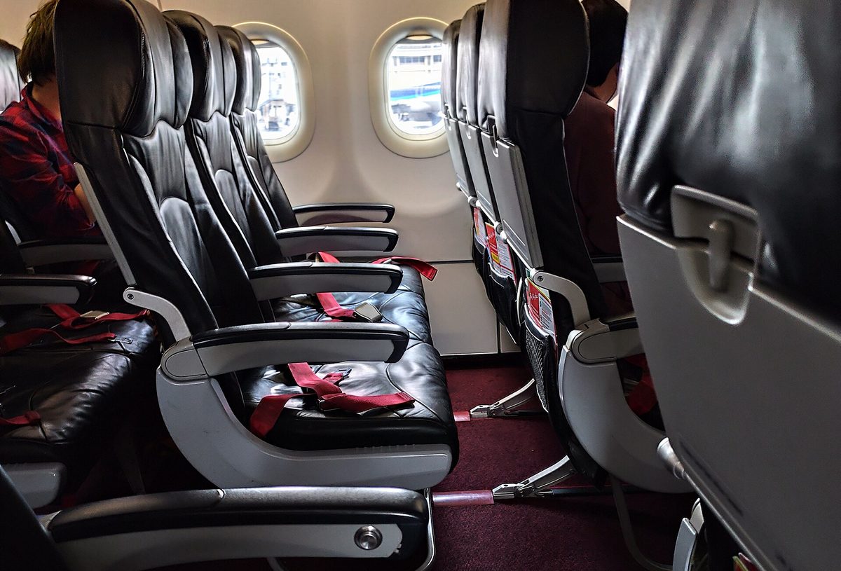 What Pilots Are Actually Saying: Every Phrase You Hear, Decoded 2 Economy cabin of an airliner where passengers hear the captain announcements over the PA