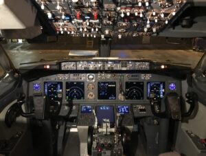 What Pilots Are Actually Saying: Every Phrase You Hear, Decoded Boeing 737 flight deck showing the radio and audio control panels between the pilot seats