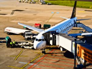 Airline pilots and ground crew at an airport gate during aircraft departure