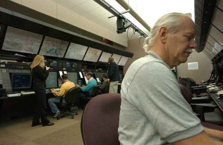 Air traffic controllers working at radar positions inside a control centre